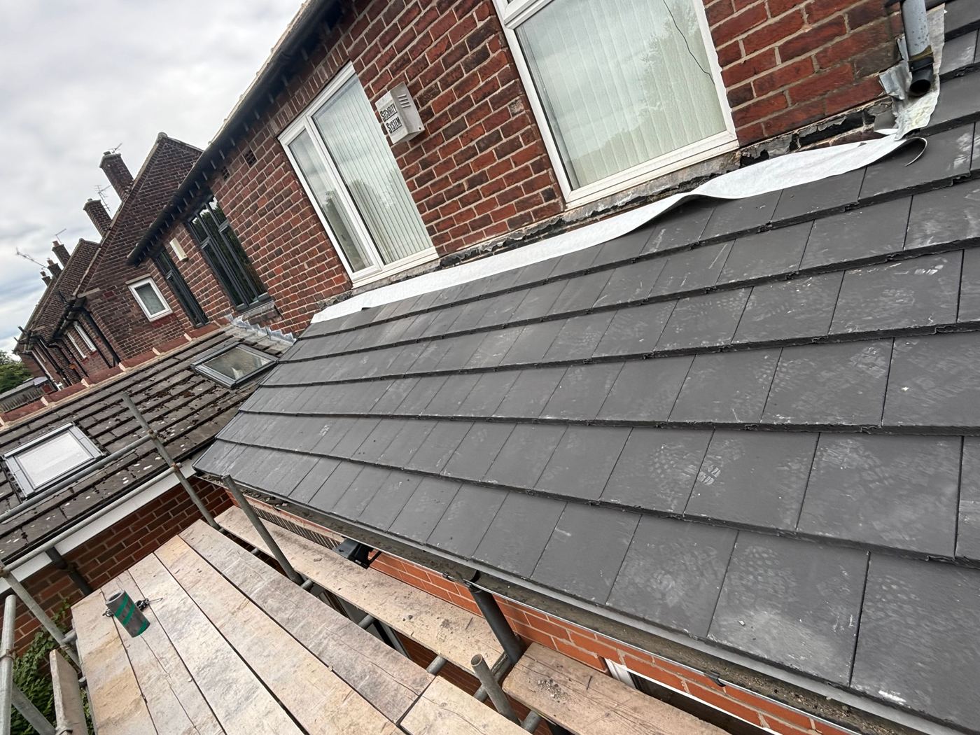 New grey tile roof installation
